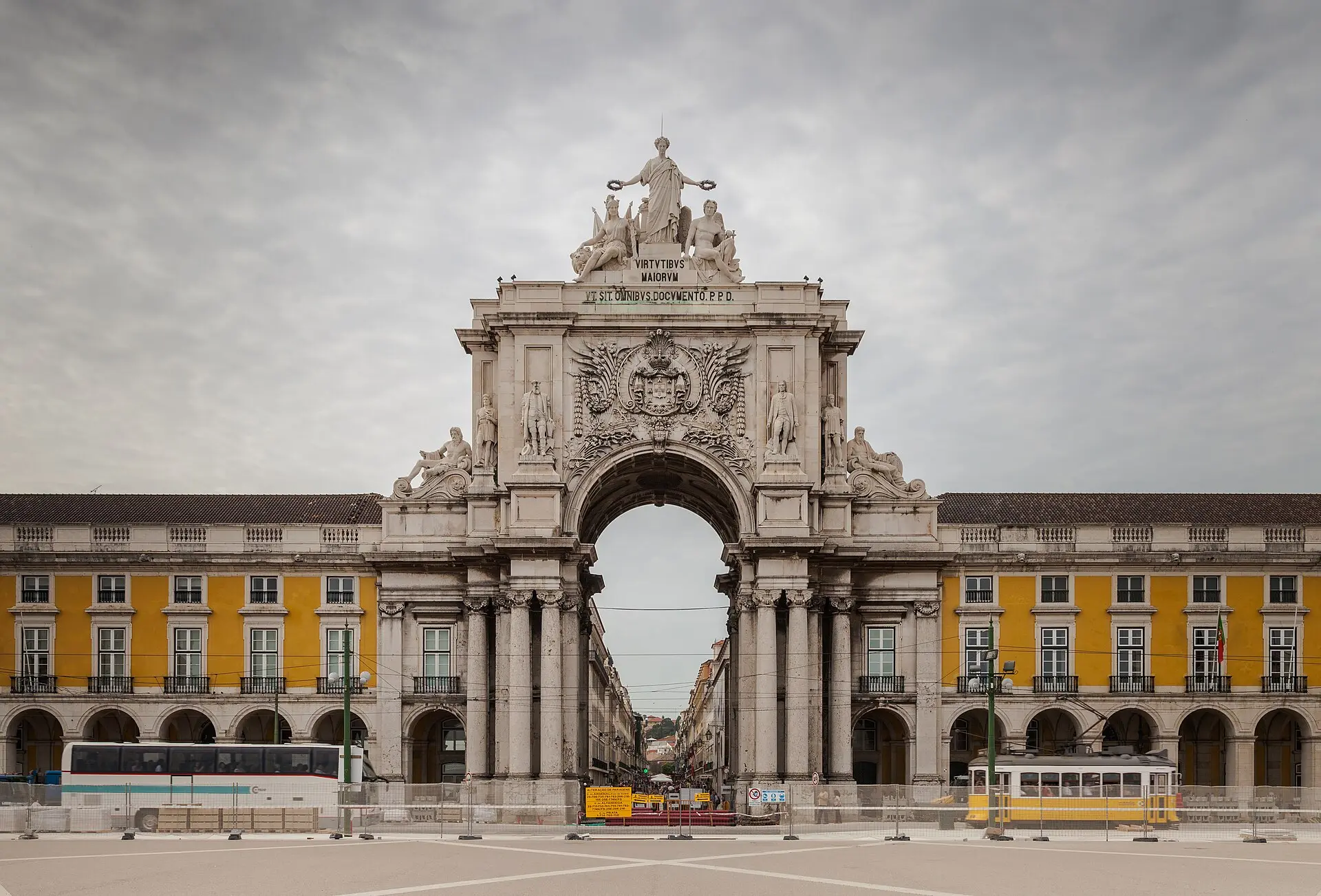 Triumphbogen der Rua Augusta an der Praça do Comércio in Lissabon, davor eine historische Straßenbahn
