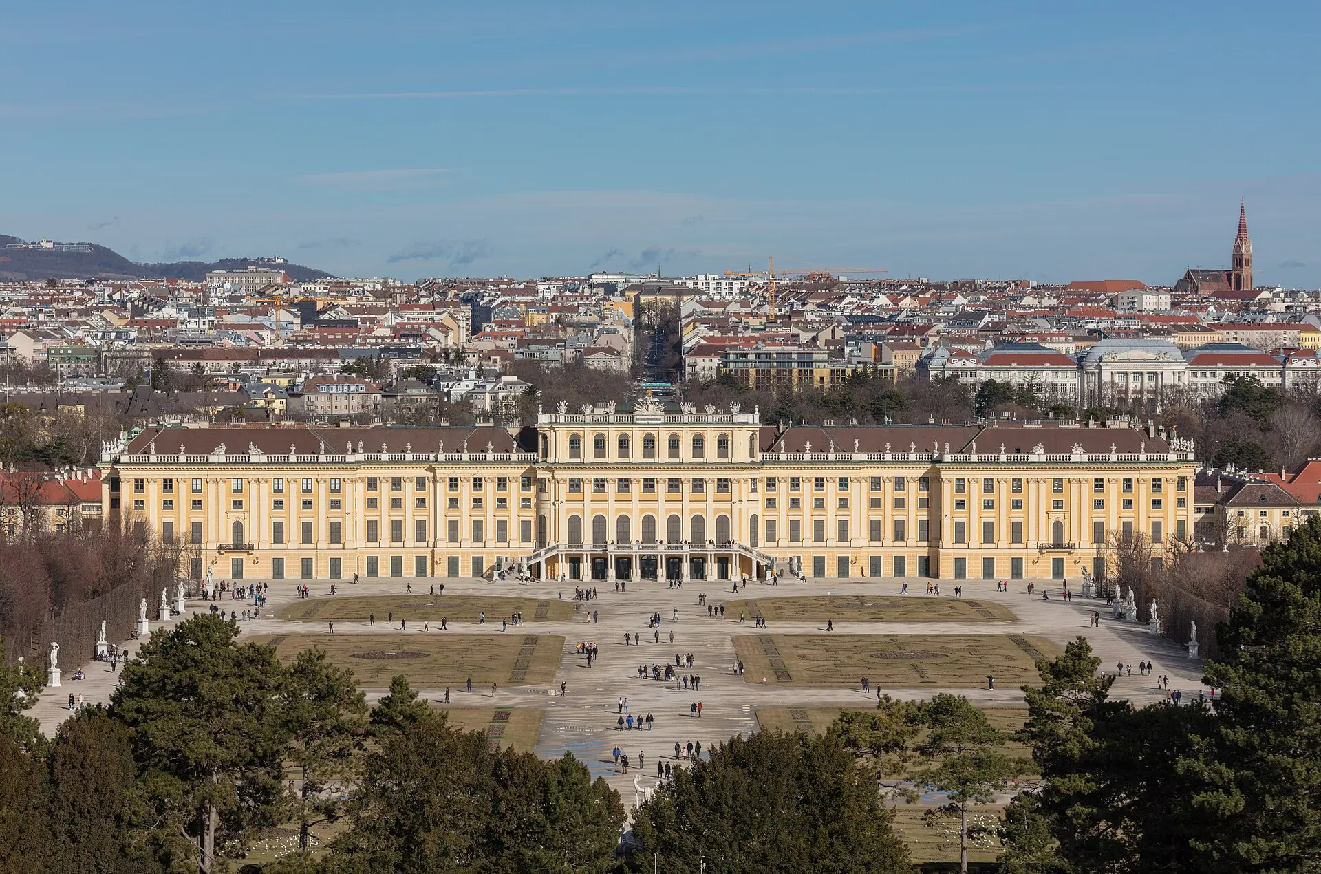 Schloss Schönbrunn in Wien mit dem Großen Parterre, vom Hang unterhalb der Gloriette aus gesehen, dahinter die Stadt